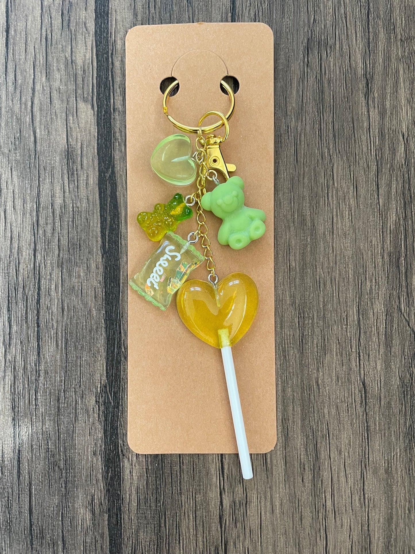 Love Candy Green Gummy Bear, Lollipop, and Hearts Gold Bag Charm